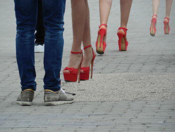 Low section of people standing on footpath