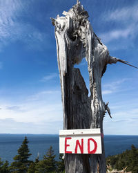 Low angle view of end sign against sky