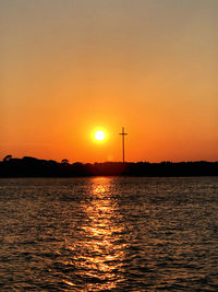 Scenic view of sea against romantic sky at sunset