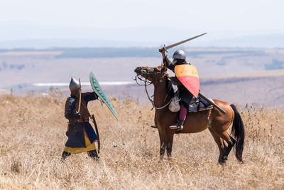 Man riding horse on field