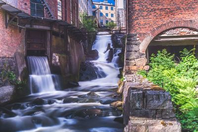 View of waterfall along buildings