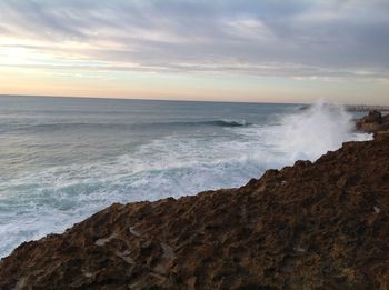 Scenic view of sea against cloudy sky