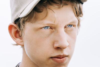 Close-up of serious man looking away against white background