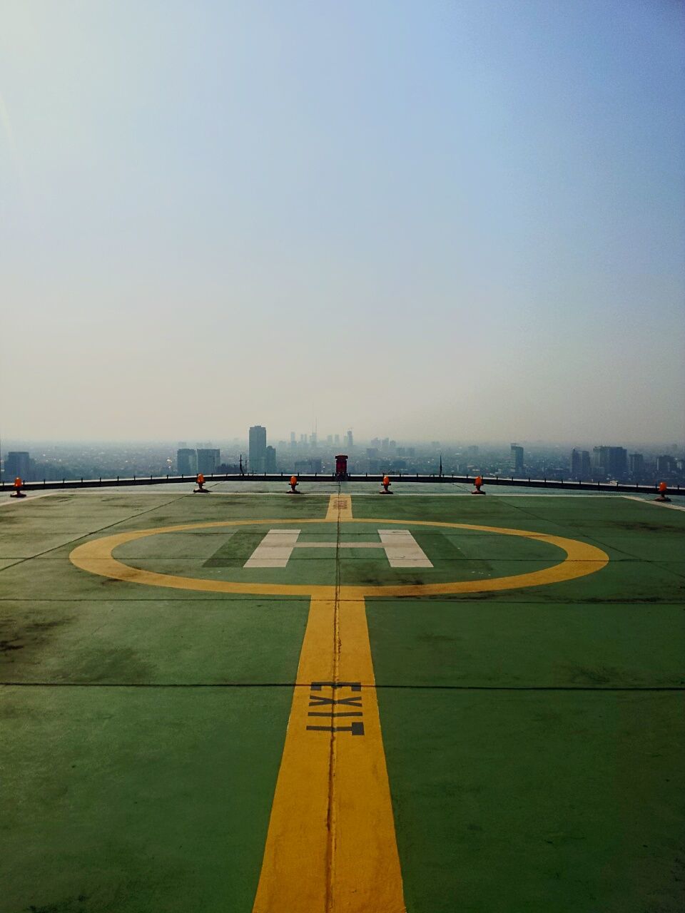 clear sky, copy space, transportation, outdoors, built structure, road, blue, travel, day, incidental people, road marking, travel destinations, tranquility, empty, architecture, shadow, water, sea, tranquil scene, sunlight