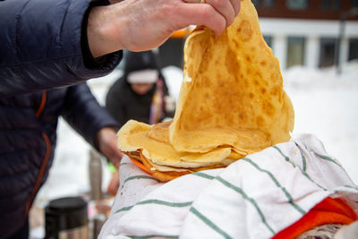 Cropped hand of person holding food