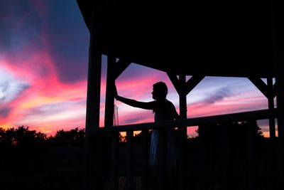 Silhouette woman standing in gazebo