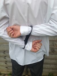 Midsection of man wearing handcuffs