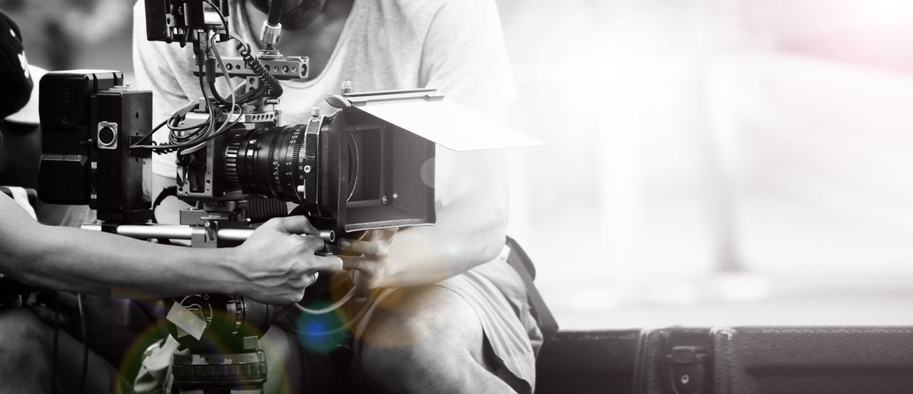 CLOSE-UP OF MAN PHOTOGRAPHING WITH MACHINE