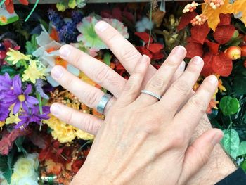 Close-up of hand holding bouquet of flowering plants