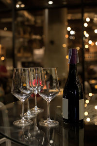 Glass of wine bottles on table