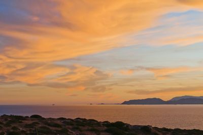 Scenic view of sea and mountains during sunset