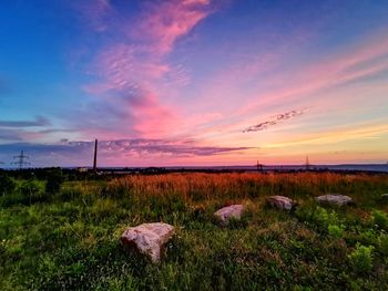 Scenic view of field against sky during sunset