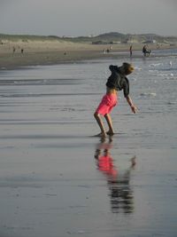 Boy standing on sea shore at beach