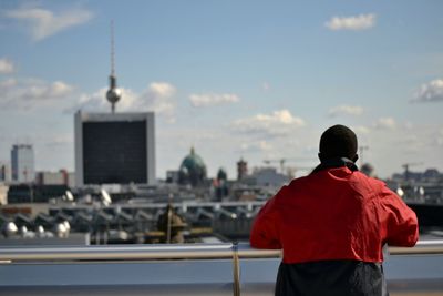 Rear view of man looking at cityscape