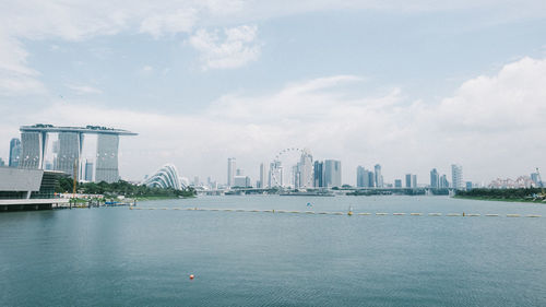 Marina bay sands by bay against sky