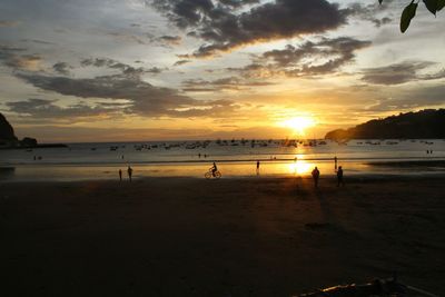 Scenic view of beach against sky during sunset