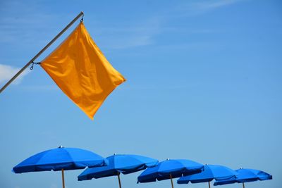 Yellow flag against blue sky