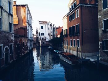 Boats in canal with buildings in background
