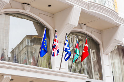 Low angle view of flags hanging on building