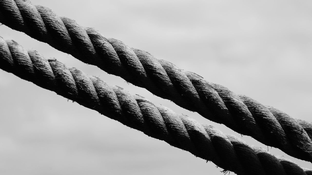 LOW ANGLE VIEW OF ROPE TIED ON METAL