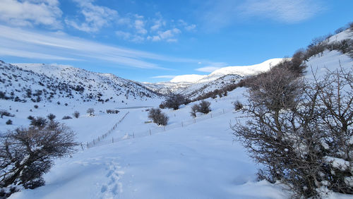 Scenic view of snowcapped mountains against sky