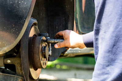 Close-up of man working on metal