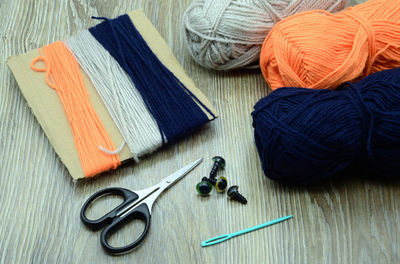 High angle view of wool and scissors on table