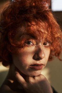 Young alternative redhead girl close up with green eyes