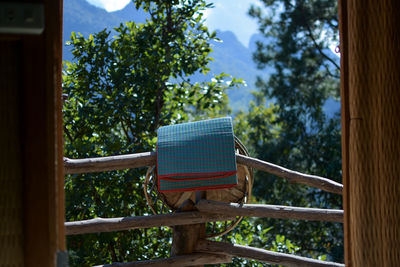 Low angle view of bench in park against sky