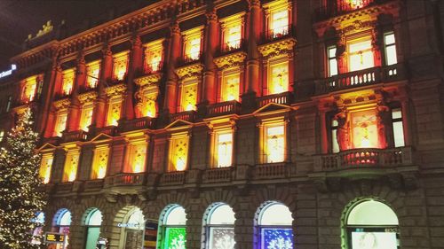 Low angle view of illuminated building at night