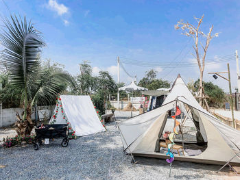 Panoramic view of people on palm trees against sky