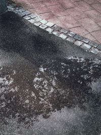 High angle view of puddle on street