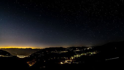 Silhouette mountain against sky at night