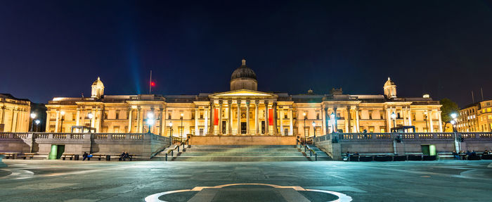 Illuminated building against sky at night