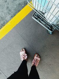 Low section of woman standing on tiled floor