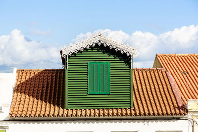 Low angle view of house roof against sky