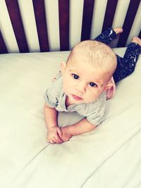 High angle portrait of baby on bed at home