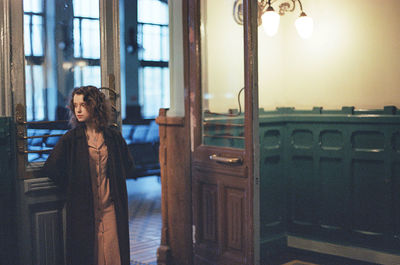 A woman is standing at the train station