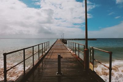 Pier over sea against sky