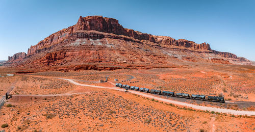 Aerial view of the cargo locomotive railroad engine crossing arizona desert