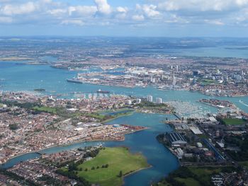 High angle view of townscape by sea against sky