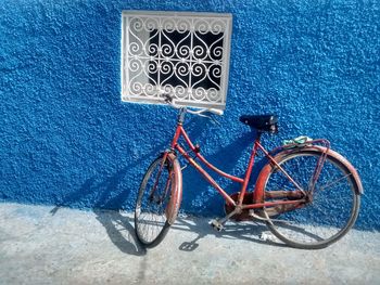 Close-up of bicycle against blue wall