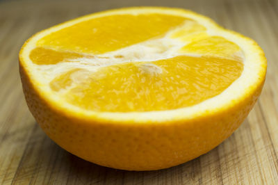 Close-up of half orange on cutting board