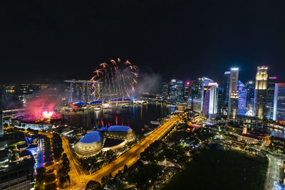 High angle view of illuminated buildings against sky at night