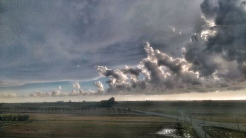 Scenic view of landscape against cloudy sky