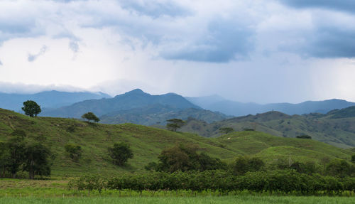 Scenic view of landscape and mountains against sky