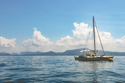 Sailboat in the sea in the sunlight background.