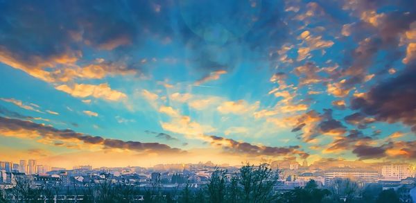 Panoramic view of cityscape against sky during sunset