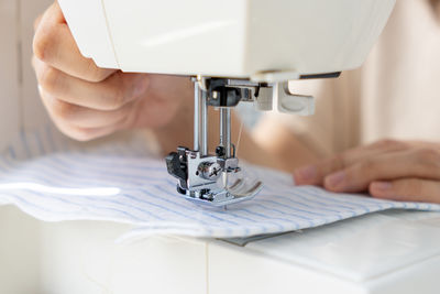Cropped hands sewing machine