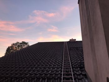 Low angle view of roof and building against sky